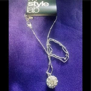 Elegant Silver tone chain and pendant.